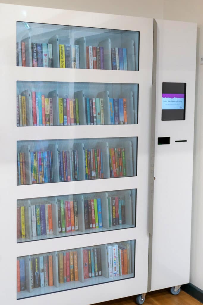 glass enclosed machine with library books inside