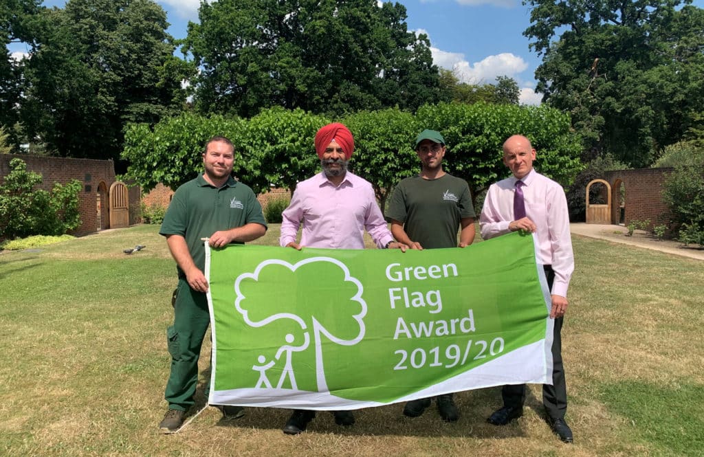staff holding up green flag award in valentines park