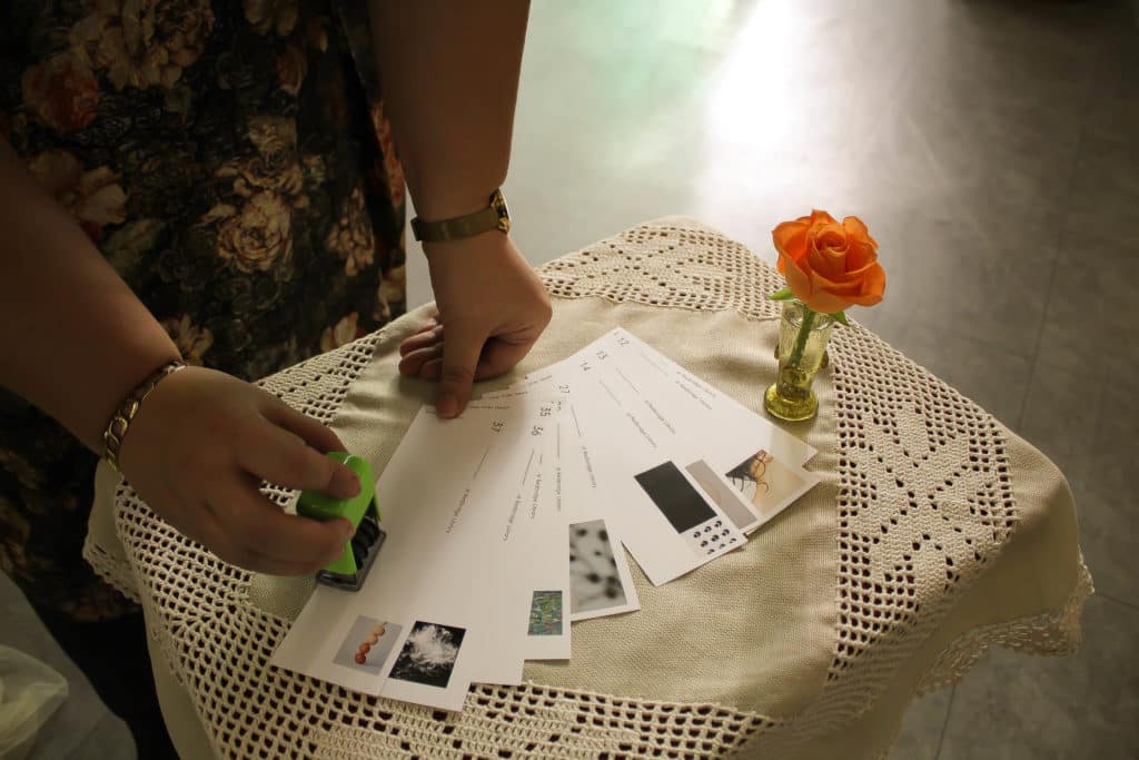 woman using stamp on postcards