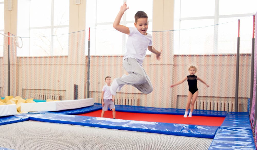 children jumping on trampoline