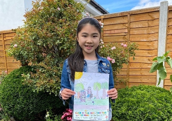 Competition winner Iris Wan holding her winning design