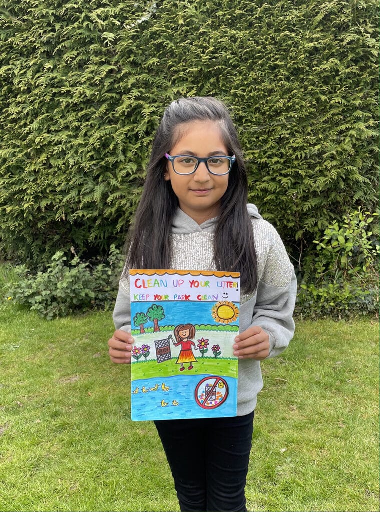 competition winner holding poster with anti-litter message