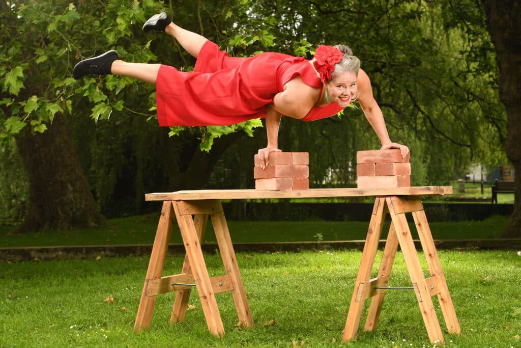 Charmaine Childs is a real life Strong Lady in the vaudeville circus style, demonstrating her body strength with a series of exercises that show her inner strength using bricks, balance and guile as she prepares to take part in the 46th Winchester Hat Fair, the longest running outdoor event in the country, which began in 1974.©Russell Sach - 0771 882 6138