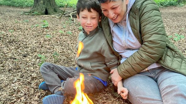 parent and son around fire at hainault forest