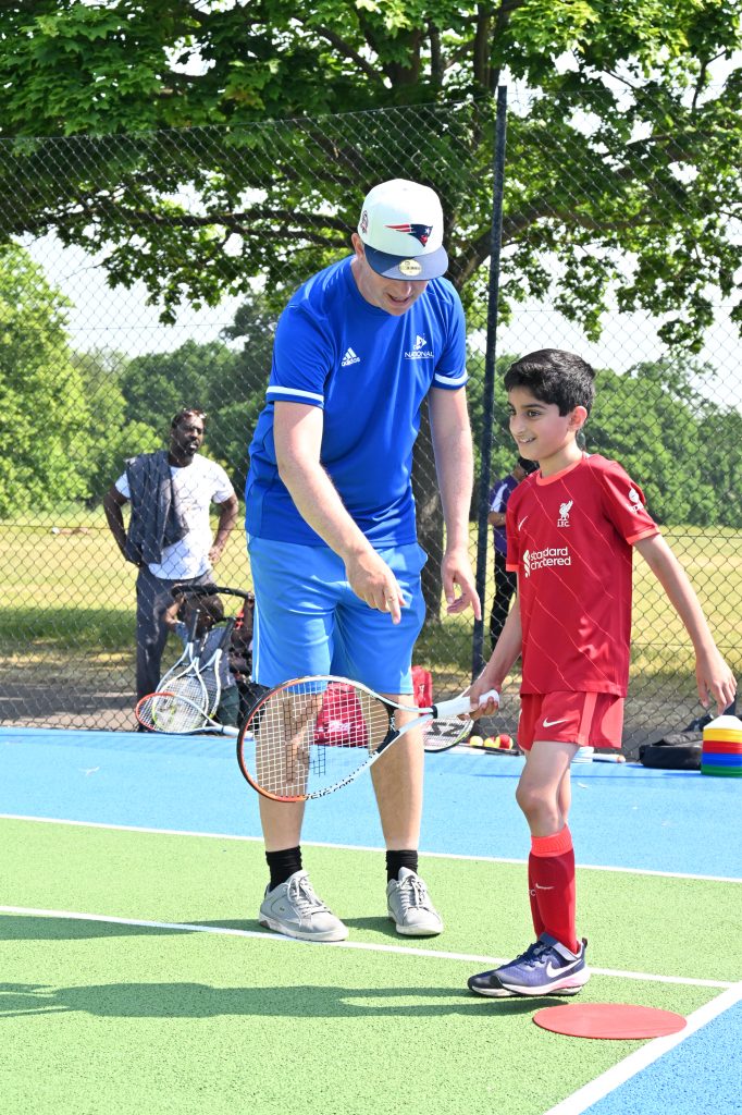 Coach and boy on tennis court, learning tennis